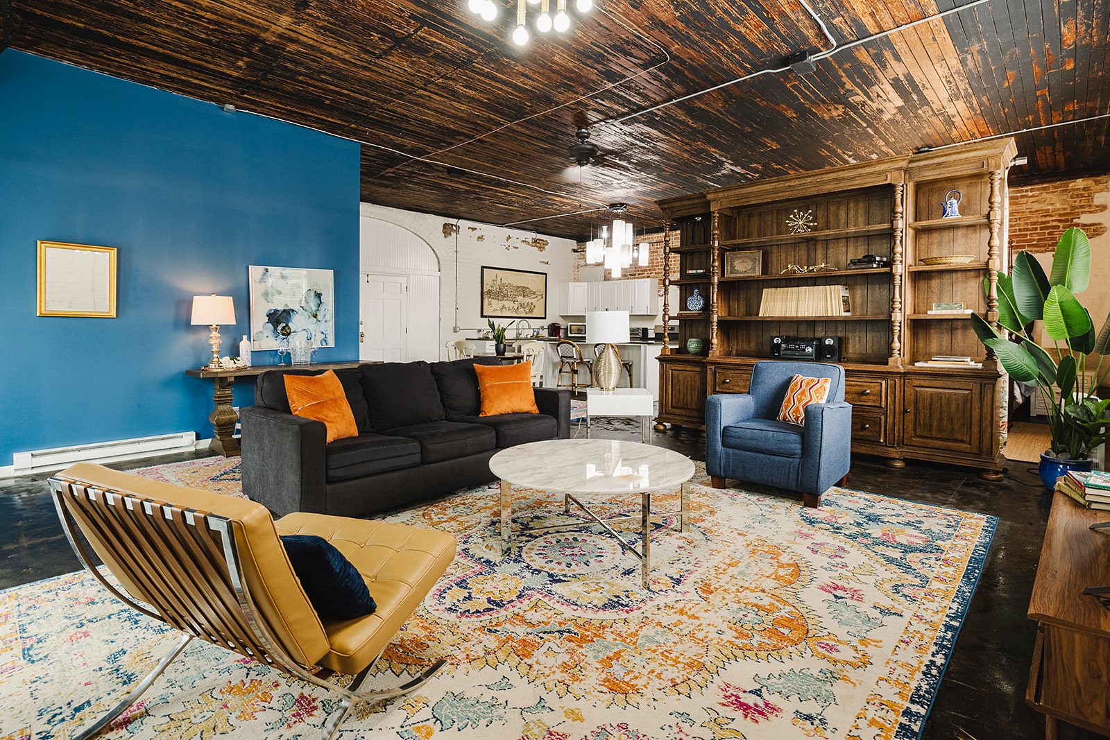 The Carriage House Loft — Lounge and library wall