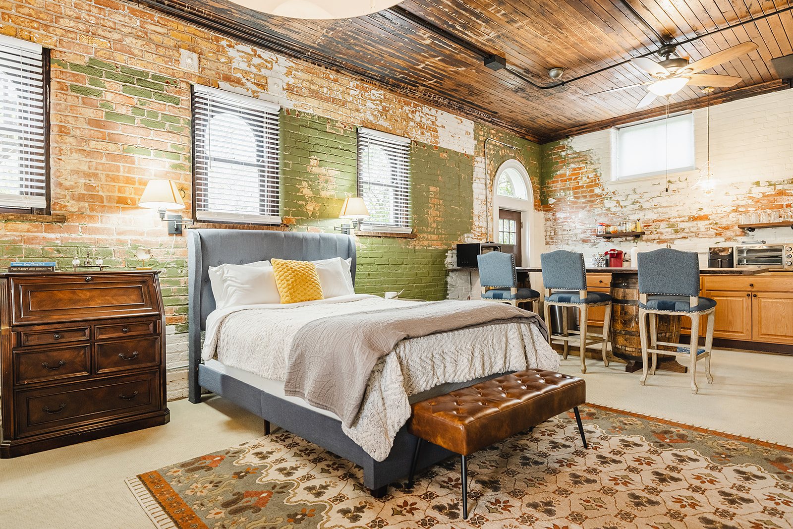 The Carriage House Studio — Bed and kitchenette